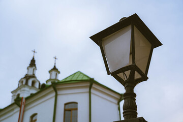 Vintage street lamp with a view of the church