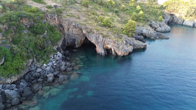 Aerial cinematographic view of gray rocks and blue sea on the Calabrian coast near Scalea city 4
