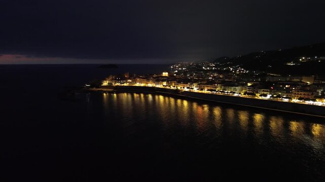 Breathtaking night aerial view over the seaside town of Diamante near Scalea in Calabria with the main street illuminated 2