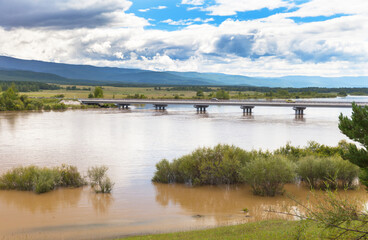 Siberia. Buryatia. Tunka foothill valley. Flooding on the Irkut River. High water flooded the banks after heavy rains. Climate change concept. Summer landscape. Natural background
