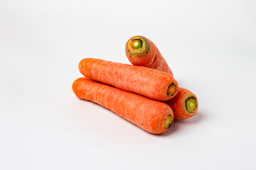 Front view and side view of fresh beautiful orange carrots with slices or pieces in a stack is...