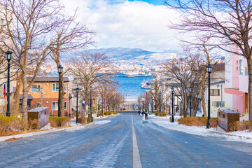 Japan - February 8, 2024 : Scenic view of Hachimanzaka Slope with Hakodate Port background, One of most popular tourist destination in Hakodate, Hokkaido