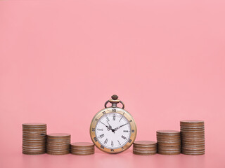 Vintage watch and stack of coins. The concept of saving money for manage time to success business.