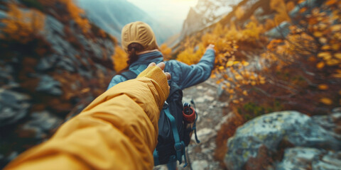 Fototapeta premium A couple hiking through an autumn-colored mountain trail, with one person leading the way, showcasing adventure and companionship.