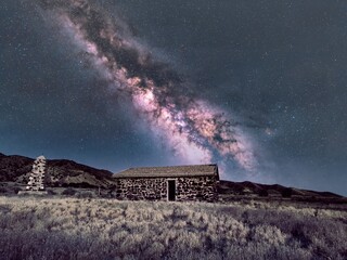 Bright Milky Way core over a ghost town cabin