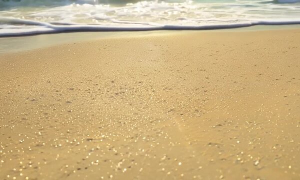  closeup footage of sea waves wahing off footprints on the golden sand at beach
