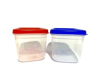 Empty two plastic jar containers with red and blue lid for storing food and materials isolated on white background