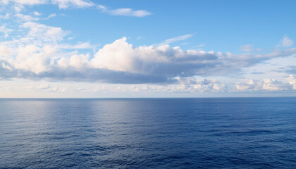 Obraz premium a beautiful blue sea with clouds. background, concept of calm and relaxation , high resolution