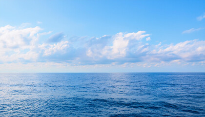 Obraz premium a beautiful blue sea with clouds. background, concept of calm and relaxation , high resolution