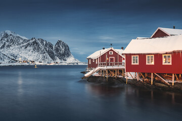 Fototapeta premium Lofoten Islands, Reine, Norway and Hamnoy fishing village with red rorbuer houses in winter nature panorama landscape