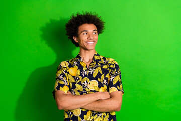 Photo of positive guy crossing arms look profile side empty space isolated green color background