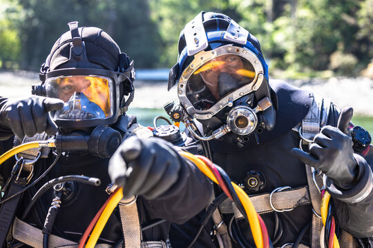 Military commercial divers with specialized helmets