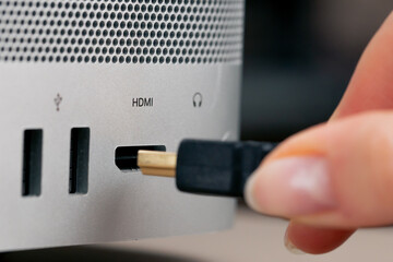 Close-up of USB ports in a computer with a metal case, many different connectors, inserted Type- wires connector designators female hand inserts HDMI
