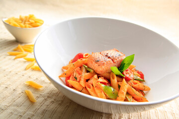 Tasty pasta with smoked salmon on a bowl