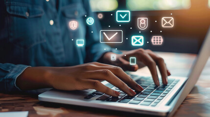 Closeup of hands typing on a laptop with digital learning icons floating in the background
