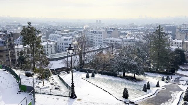 Panoramic cityscape of Paris under snow.