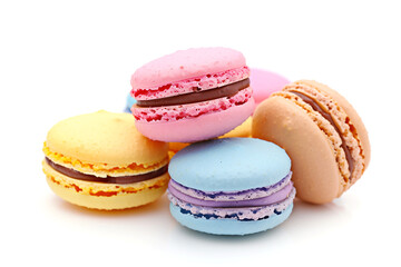 Obraz premium Assorted colorful Macarons stacked together on white background in a sweet display. Generative AI.