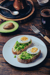 Toasts with mashed avocado, cream cheese and boiled egg