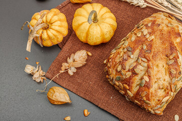 Fresh bread with pumpkin seeds. Home baking concept. Autumn decor