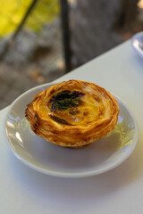 Delicious Portuguese custard tart with a perfectly crisp pastry shell, lightly caramelized on top. A traditional treat that’s both sweet and creamy.