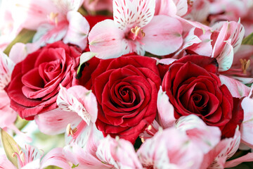 A bouquet of red roses and pink flowers