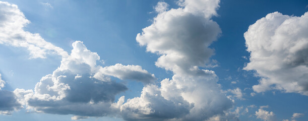White puffy clouds and blue sky above Vlasina Lake. White cumulus clouds and a blue sky with sun...