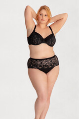 Portrait of a attractive young woman plus size in underwear model posing isolated on a white background mockup. White female, laughing and feeling confident. Clipping path. Body positivity - AI photo
