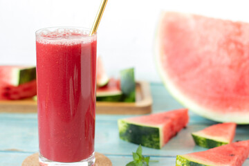 Watermelon fruit smoothie with mint placed on wooden table with white background. Close-up. Summer...