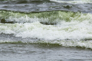 Large wave ridges with foam during a storm.