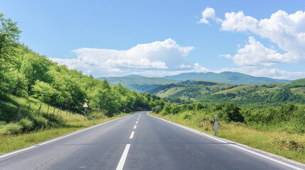 Naklejka premium Picturesque view of mountain road along mountain ridges and trees. Background with beautiful road and mountain view