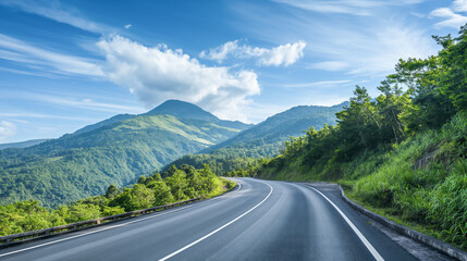 Fototapeta premium Picturesque view of mountain road along mountain ridges and trees. Background with beautiful road and mountain view