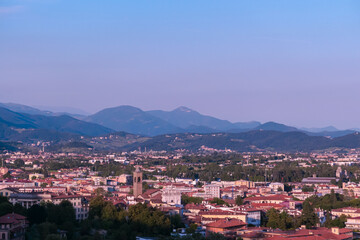 Aerial view of historic medieval walled city of Bergamo seen from Città Alta (Upper Town), Lombardy, Northern Italy, Europe. Alpine landscape of Italian Alps, historical buildings and the towers