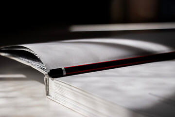 Red Pencil Resting on Open Book
A close-up video showcasing a red pencil resting on the pages of an...