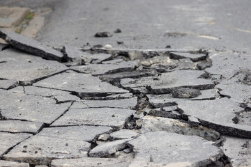 A cracked road with a lot of debris