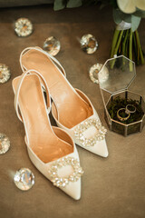 Wedding details, wedding rings, shoes, wedding bouquet. Morning of the bride.