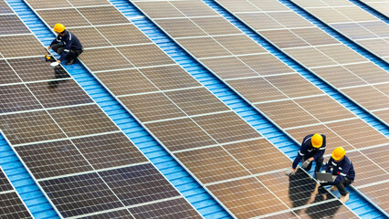 Worker Technicians are working to construct solar panels system on roof. Installing solar...