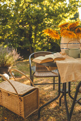 Summer morning in the garden. Book, sunflowers and tea, mood