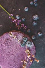 Cake with blueberries and lavender on a black background