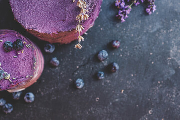 Cake, cupcake and donuts top view, background