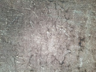 The background is made of an old worn, gray-black surface