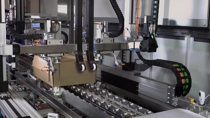 automatic packing machine. Robotic product packaging line. Automatic clothing packaging conveyor