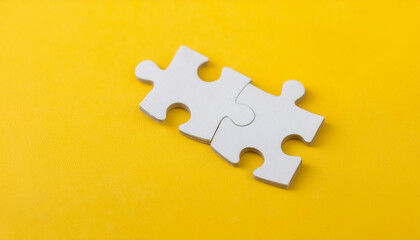 Obraz premium White puzzle pieces on yellow background. Brain game.