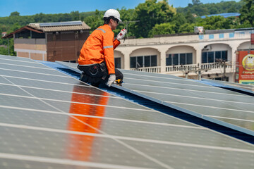 Worker Technicians are working to construct solar panels system on roof. Installing solar photovoltaic panel system. Men technicians walking on roof structure to check photovoltaic solar modules.