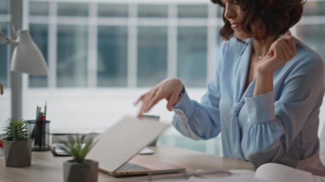 Tired worker closing computer feeling unmotivated at office desk closeup. 