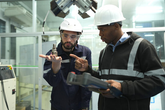 Engineer check and control welding robotics automatic arms machine in intelligent factory automotive industrial with monitoring system software. Digital manufacturing operation.