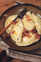 Dumplings, with fried prosciutto, a traditional dish of Polish cuisine, dumplings, top view, close-up, without people,