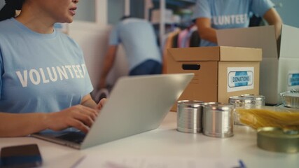 Multiethnic team of volunteers packing donated goods, organizing charity event - Powered by Adobe