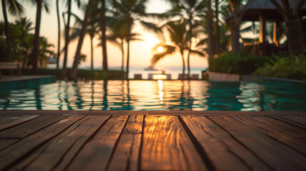 View from the wooden deck of the infinity pool on the beach, ocean and tall palm trees.