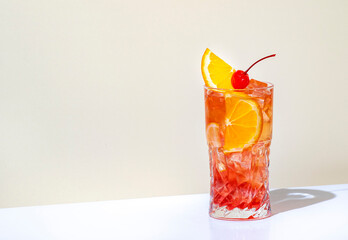 Summer red  alcoholic cocktail drink with vodka, liqueur, orange, cranberry, juice, lemon and ice...