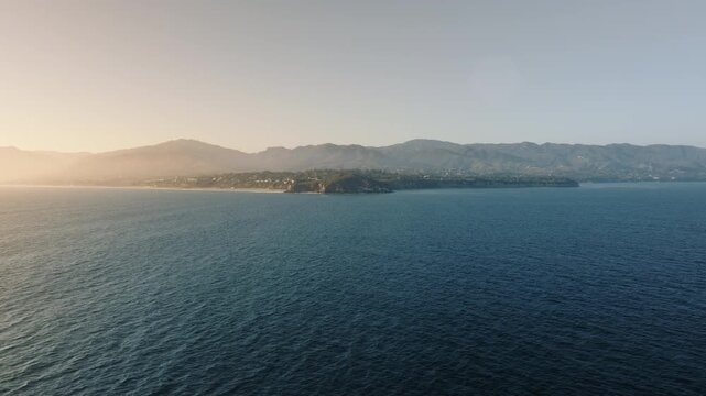 Point Dume in Malibu provides a breathtaking view of the ocean and mountains during sunset, radiating peace and awe. The surroundings evoke tranquility and showcase natures beauty